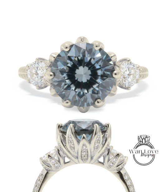 A silver engagement ring with a large blue gemstone, surrounded by smaller diamonds.