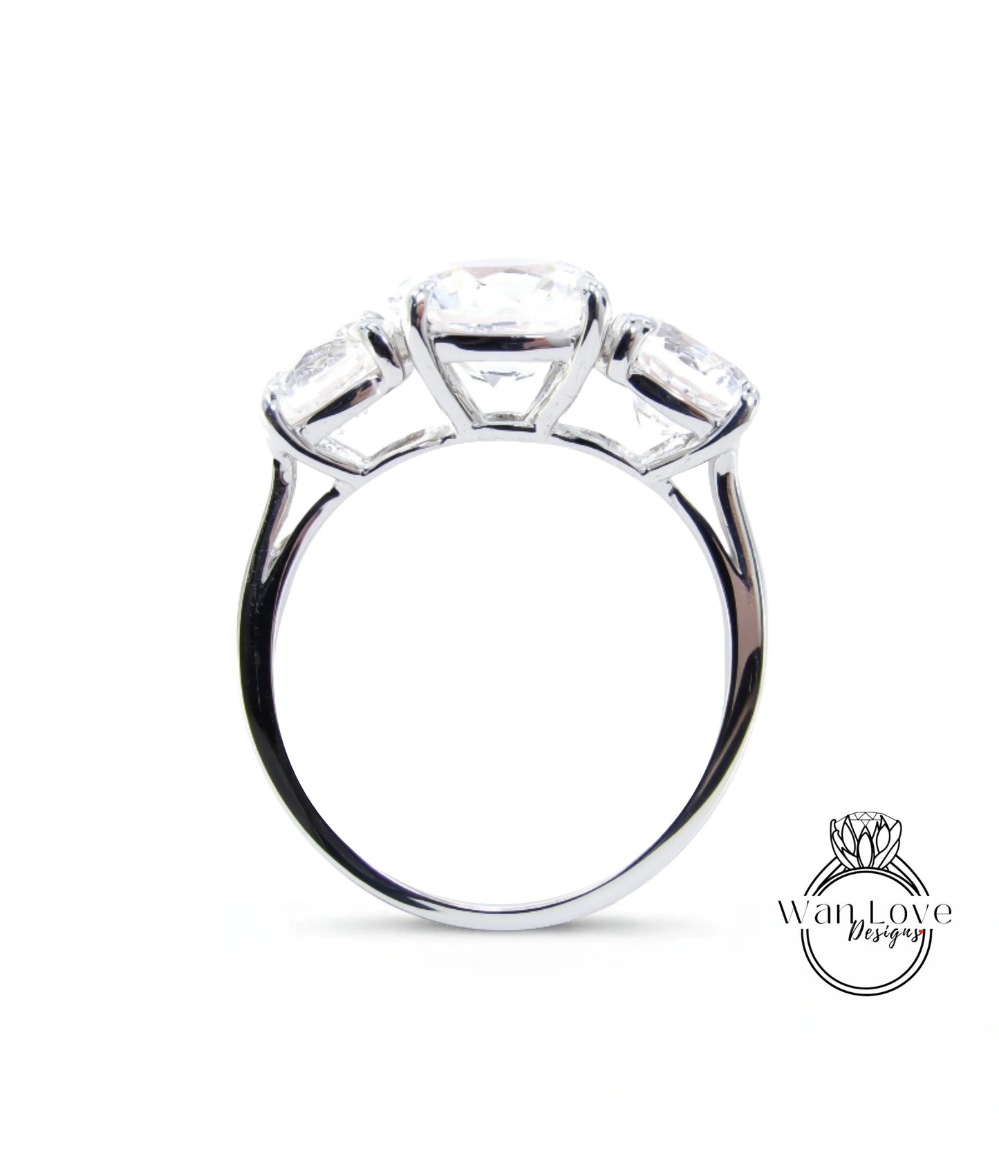 A silver ring with three large diamonds set in the center.