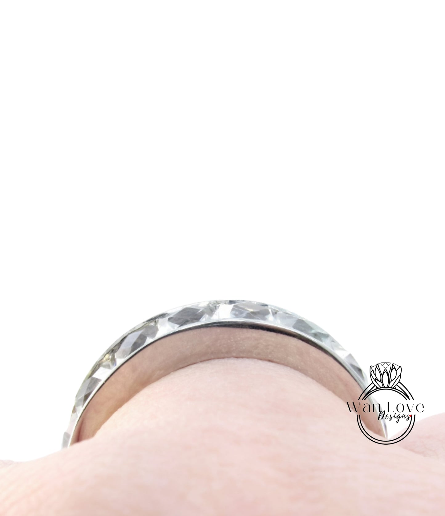 A close-up view of a silver ring on a person's finger.