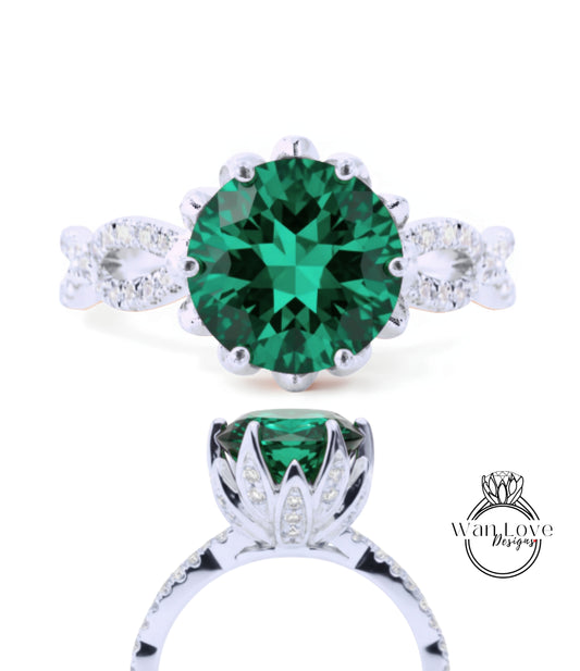 A stunning green gemstone ring with a silver band and intricate detailing.