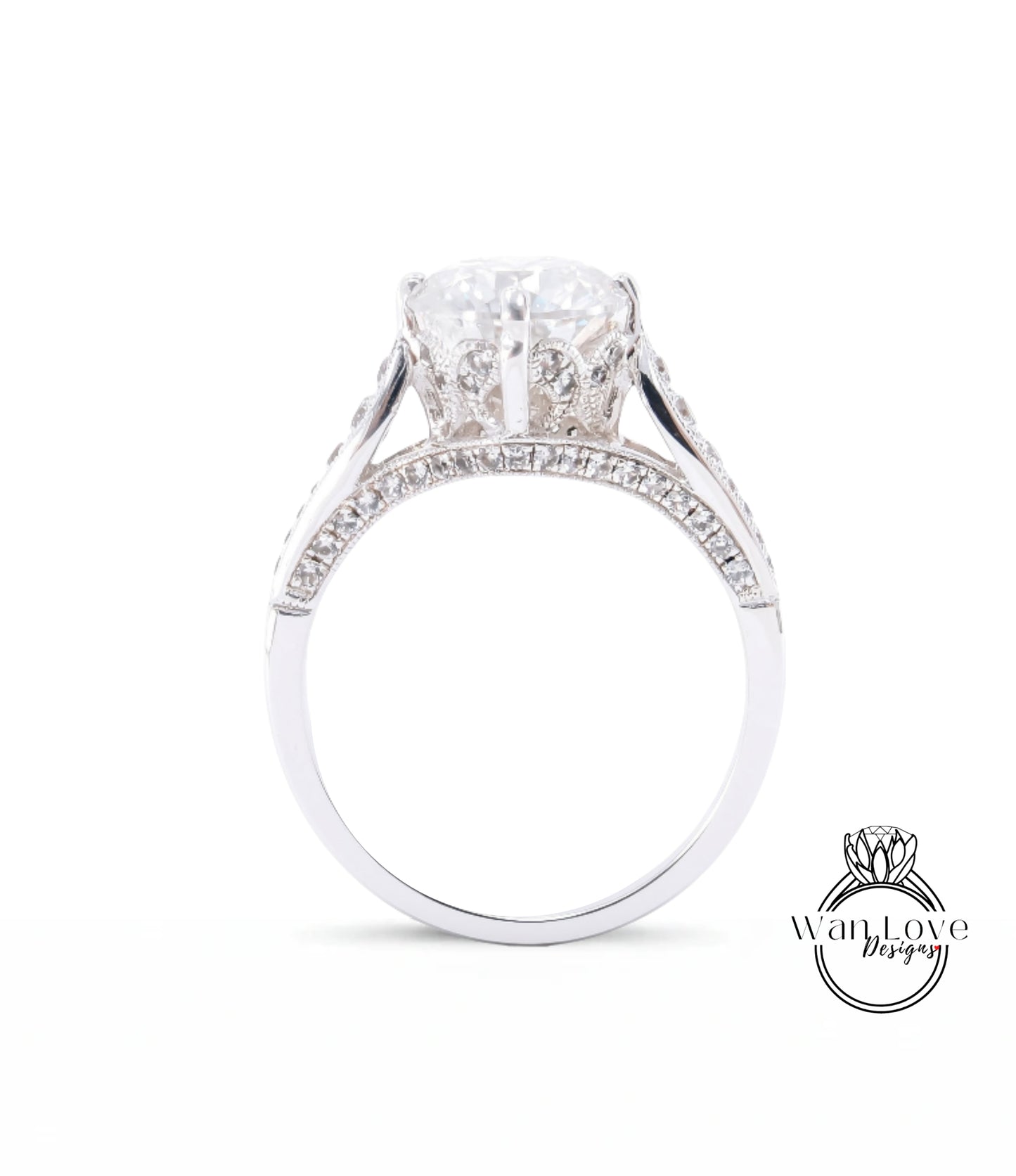 A close-up view of a diamond engagement ring with a large central diamond surrounded by smaller diamonds set in a silver band.