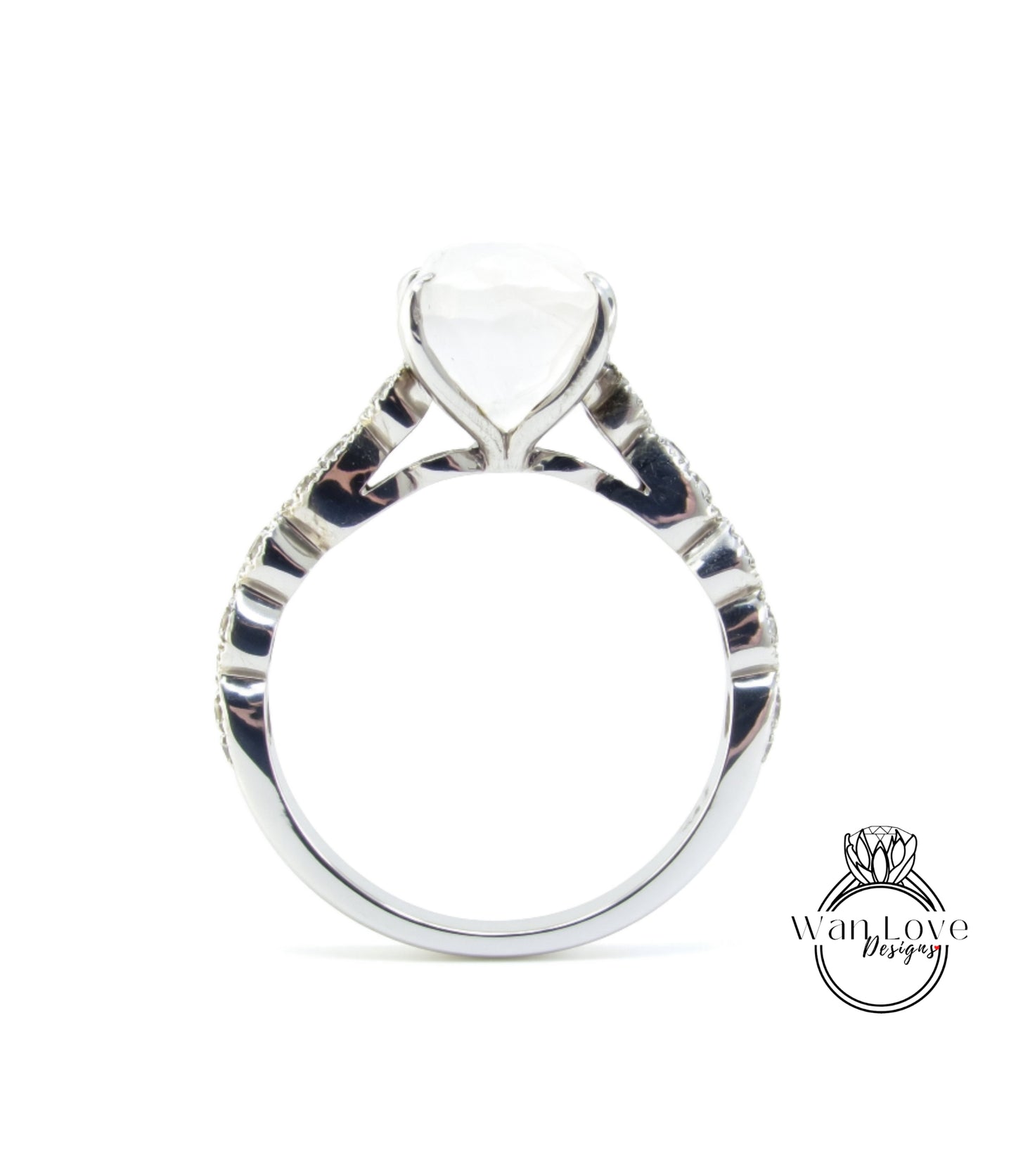 A silver engagement ring with a large white gemstone set in the center.