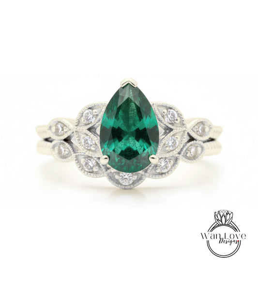 A close-up of a silver ring with a large, green gemstone at the center, surrounded by smaller diamonds.