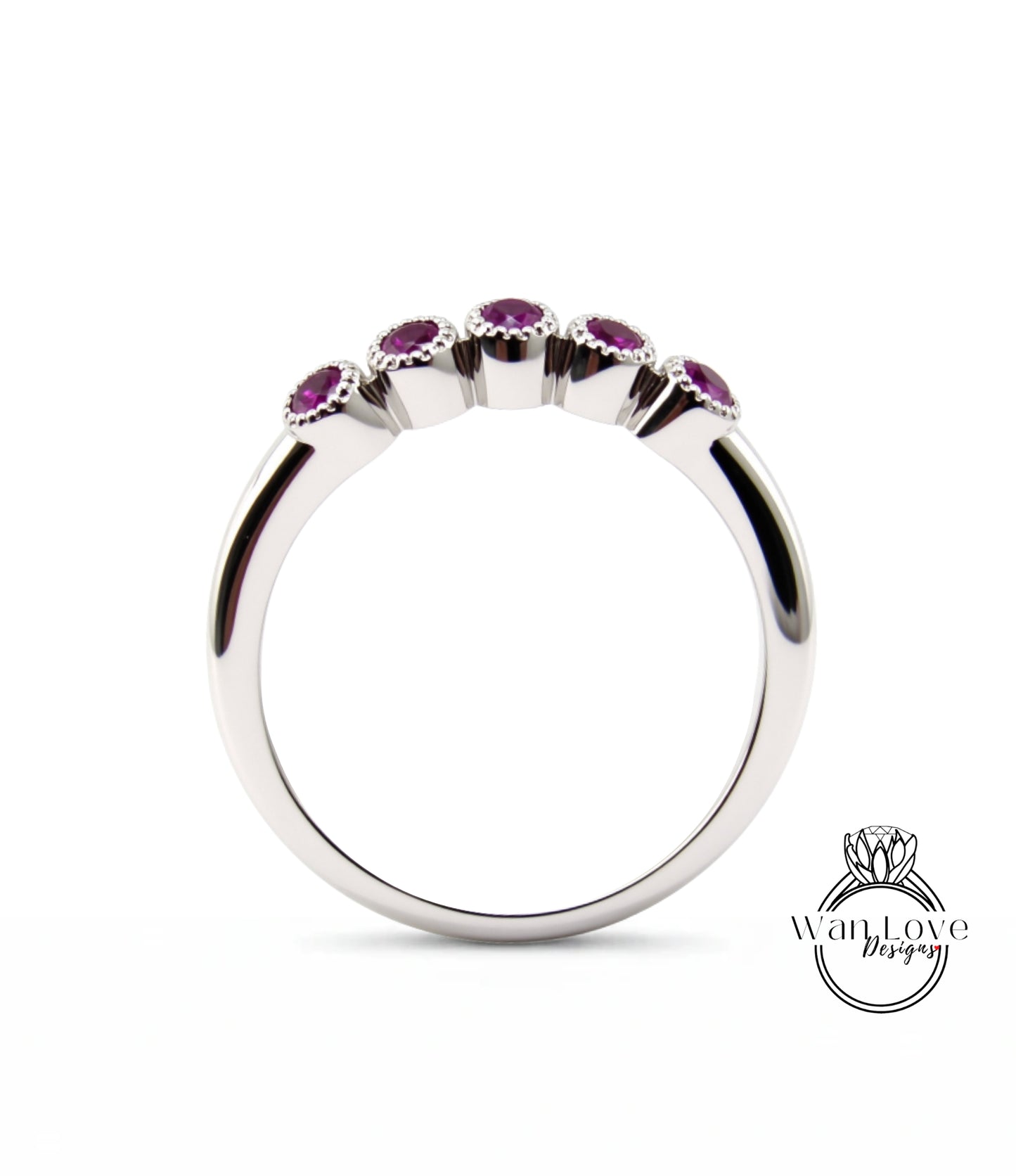 A silver ring with a row of five purple gemstones set in the center.