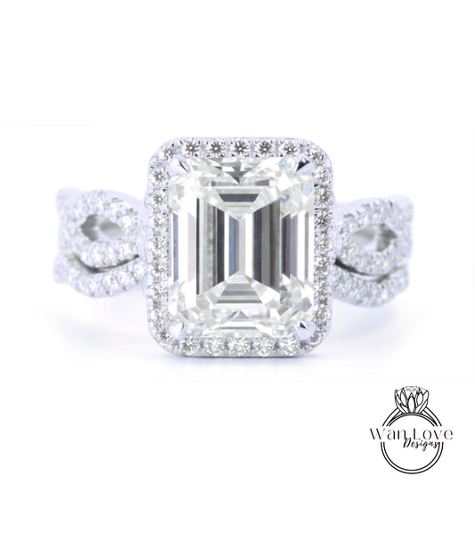 A stunning diamond engagement ring with a large, brilliant-cut emerald cut gemstone set in a halo of smaller diamonds, surrounded by a halo of smaller diamonds.