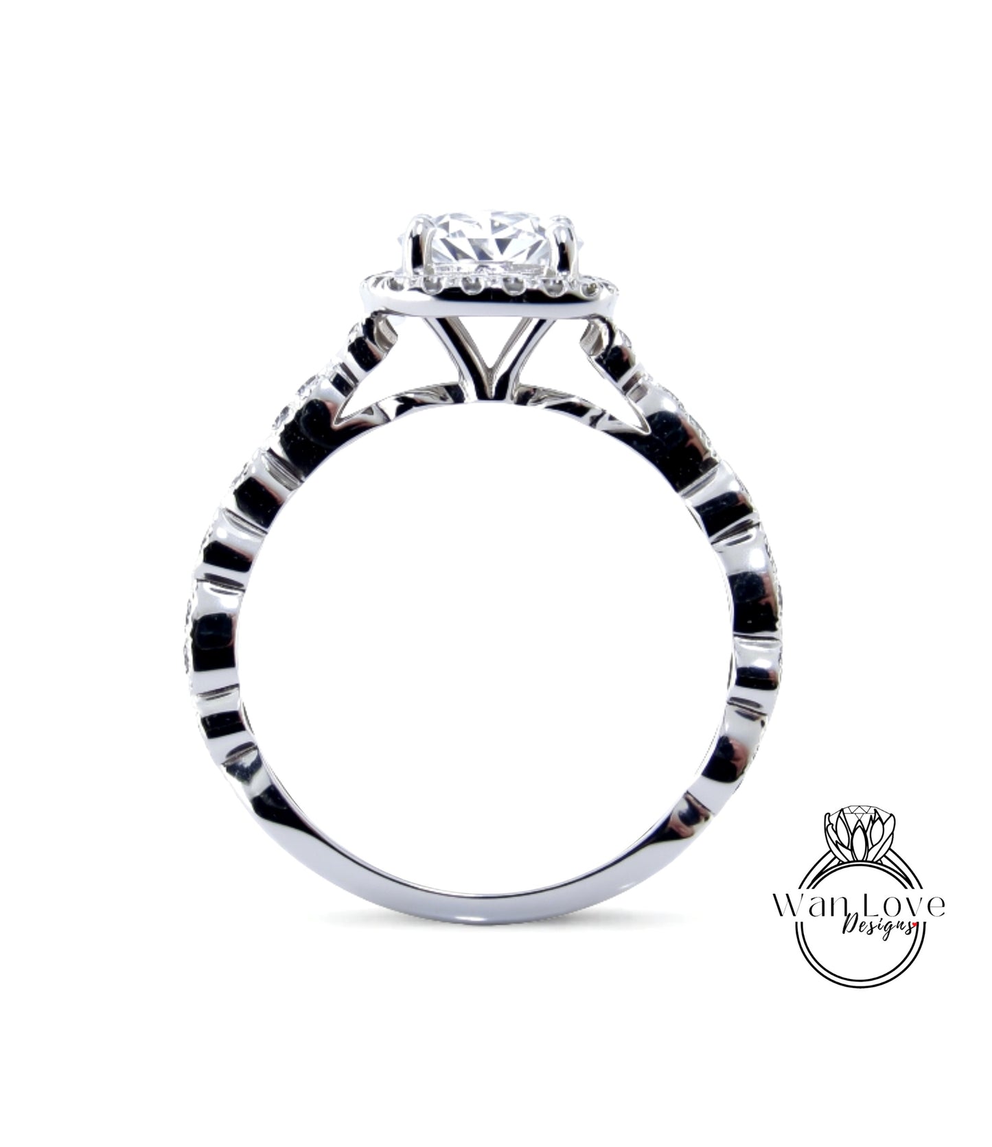 A close-up view of a silver engagement ring with a large central diamond surrounded by smaller diamonds.