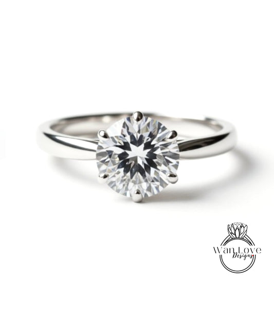 A close-up view of a diamond engagement ring with a large, brilliant-cut diamond set in a silver band.