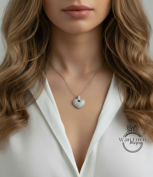 A close-up of a woman's neck and chest area, featuring a delicate necklace with a heart-shaped pendant.