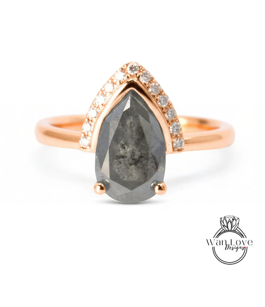 a ring with a large grey diamond as the centerpiece, surrounded by smaller diamonds and set in a gold band.