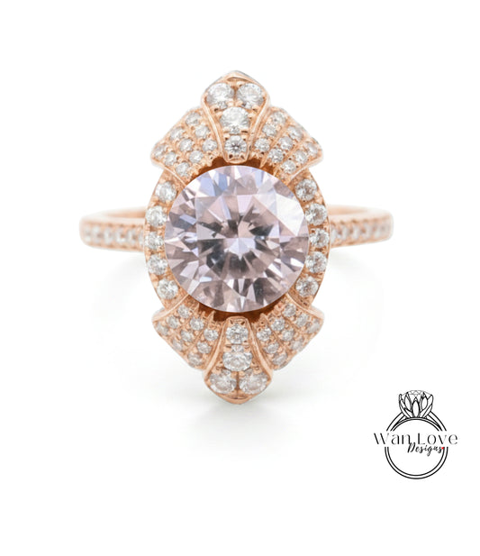 a beautiful pink gemstone ring with a large central gemstone surrounded by smaller diamonds.
