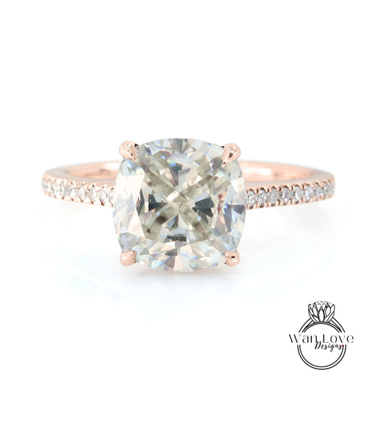 A rose gold engagement ring with a large, clear gemstone set in the center.