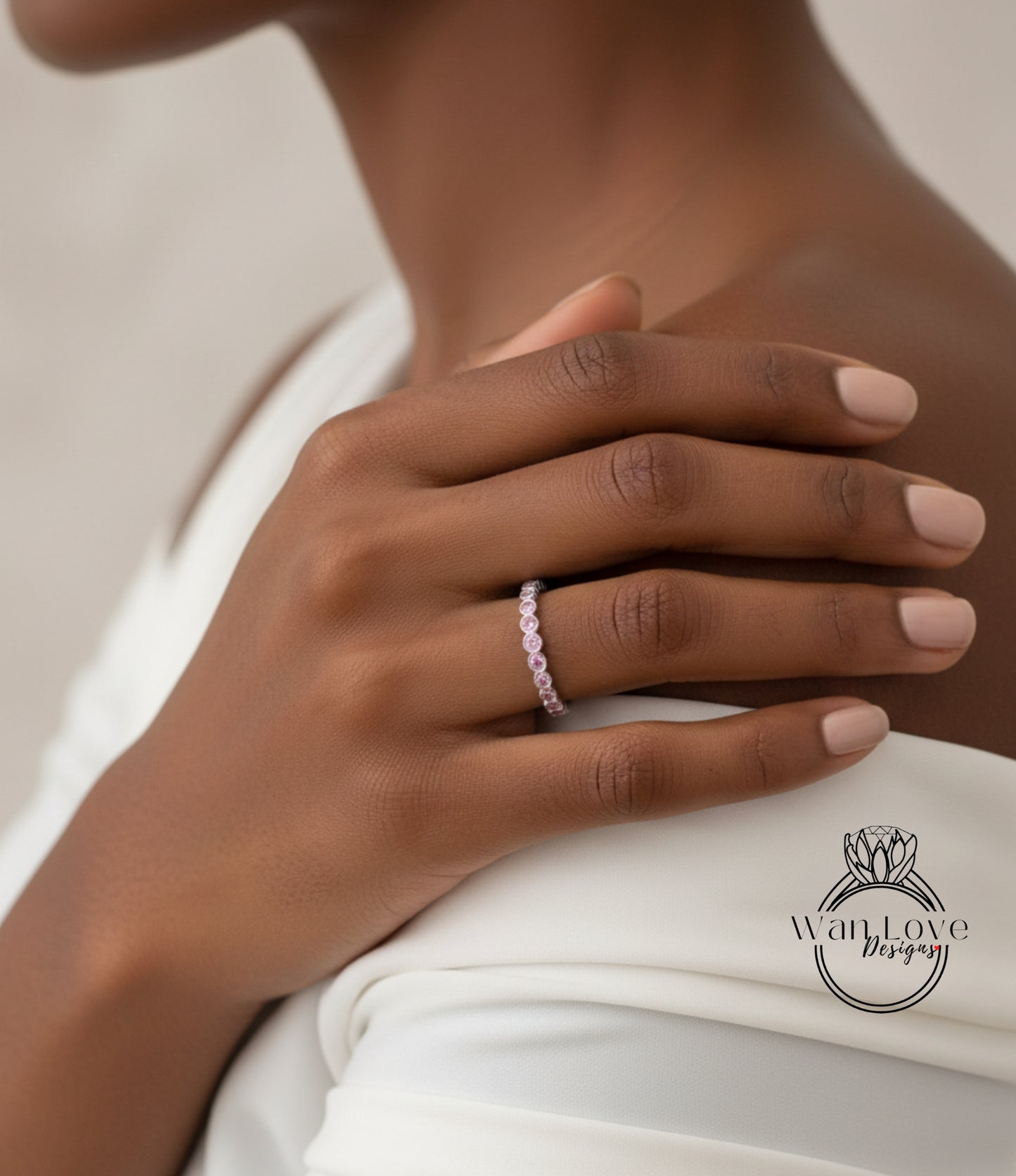 A close-up of a person's hand wearing a ring on the ring finger.