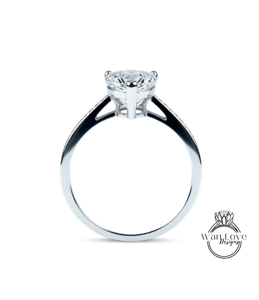 A silver engagement ring with a large diamond set in the center.