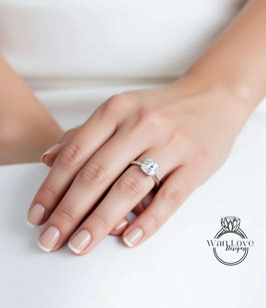 A close-up of a person's hand wearing a diamond engagement ring.