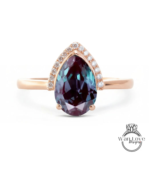 A gold ring with a large, deep purple gemstone set in the center, surrounded by smaller diamonds.