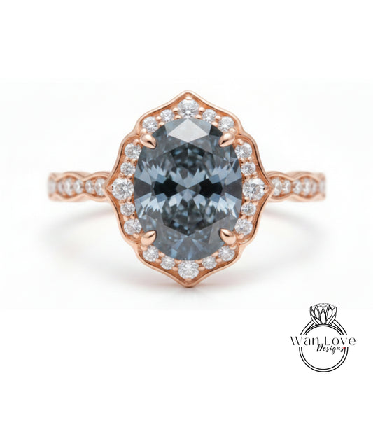 A rose gold ring with a large oval-shaped blue gemstone set in the center, surrounded by smaller diamonds.