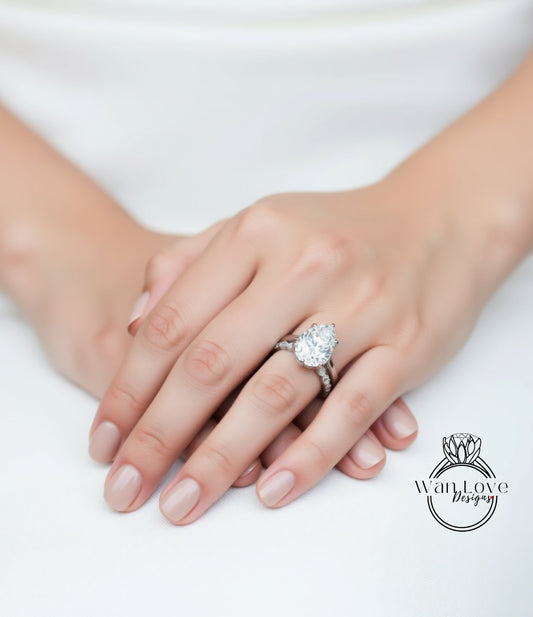 A close-up of a person's hands wearing a large diamond engagement ring.