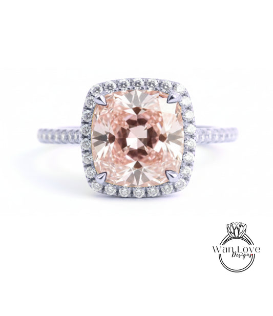 A large, pink diamond ring with a halo of smaller diamonds around the center stone.