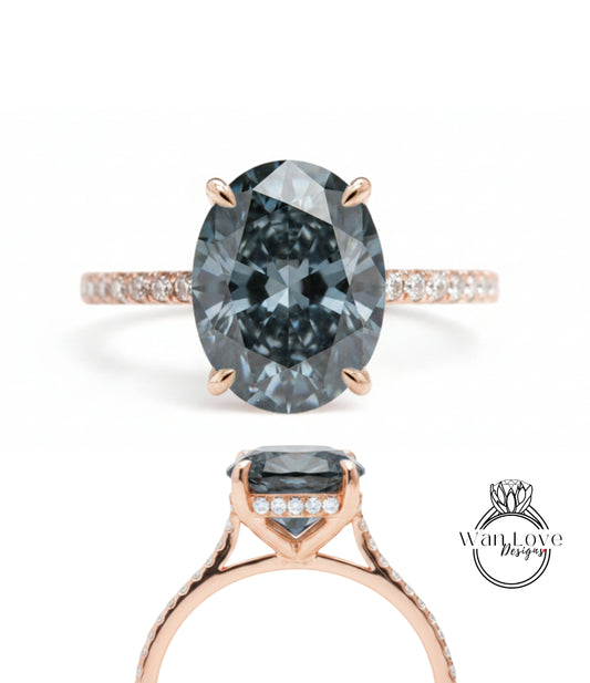 a beautiful engagement ring with a large oval-shaped blue diamond set in a rose gold band. The ring is adorned with small diamonds around the band, adding to its elegance and sophistication.