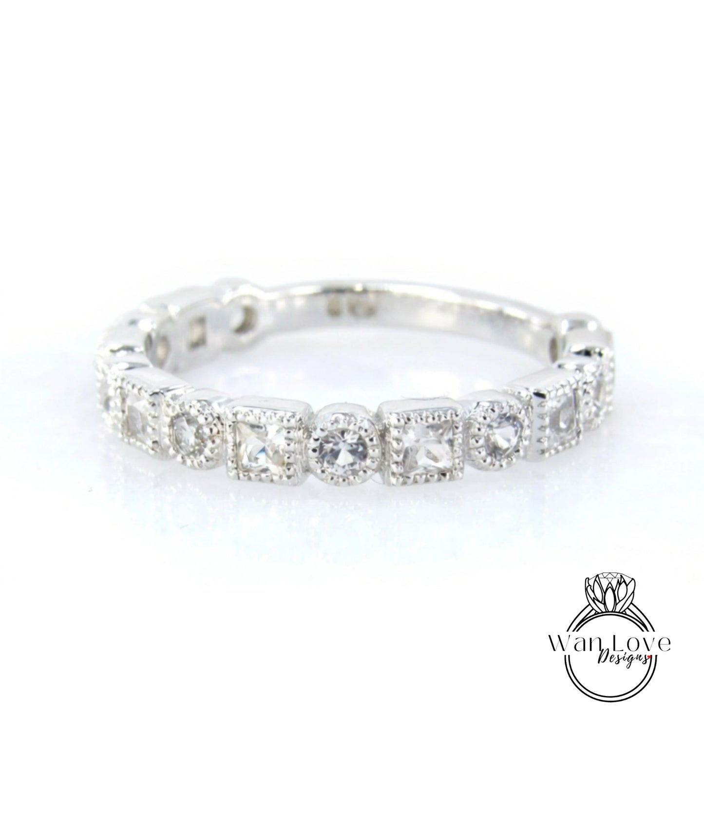 A silver ring with a row of small diamonds set in the center.