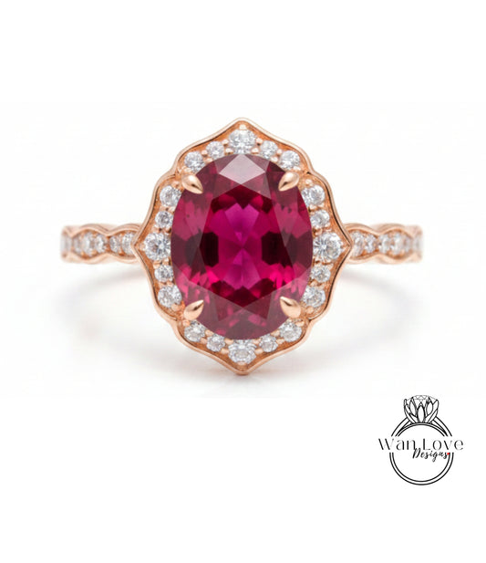 A beautiful pink gemstone ring with a large oval-shaped gemstone at the center, surrounded by a halo of smaller diamonds.
