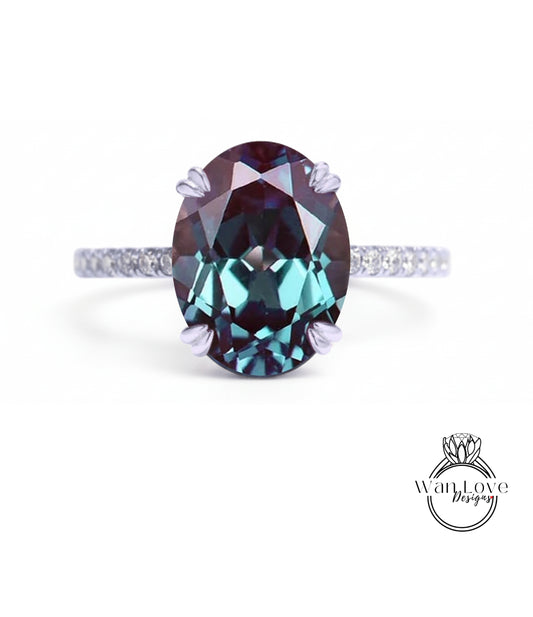 A large oval-shaped gemstone, possibly a sapphire or amethyst, set in a silver ring with a thin band.