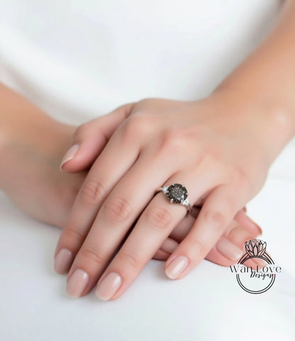 A close-up image of a person's hand wearing a ring with a large black gemstone.