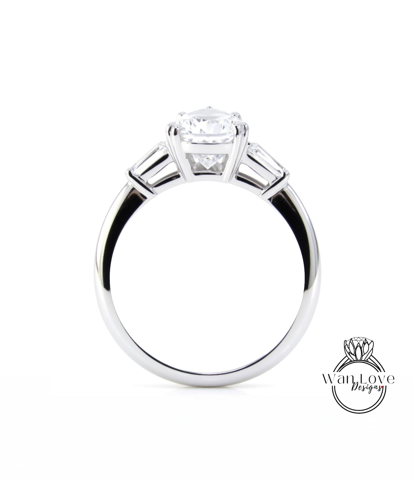 A close-up view of a silver engagement ring with a large central diamond and three smaller diamonds on either side.