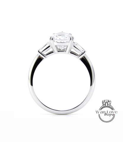 A close-up view of a silver engagement ring with a large central diamond and three smaller diamonds on either side.