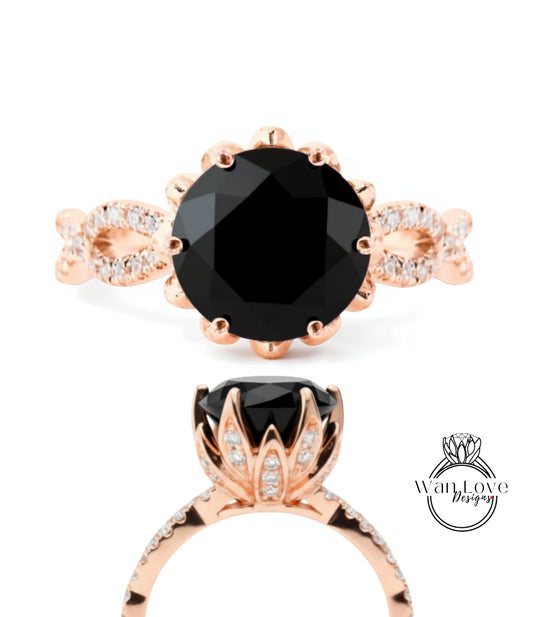 a beautiful rose gold ring with a large black gemstone, likely a diamond, set in a delicate flower-like design.
