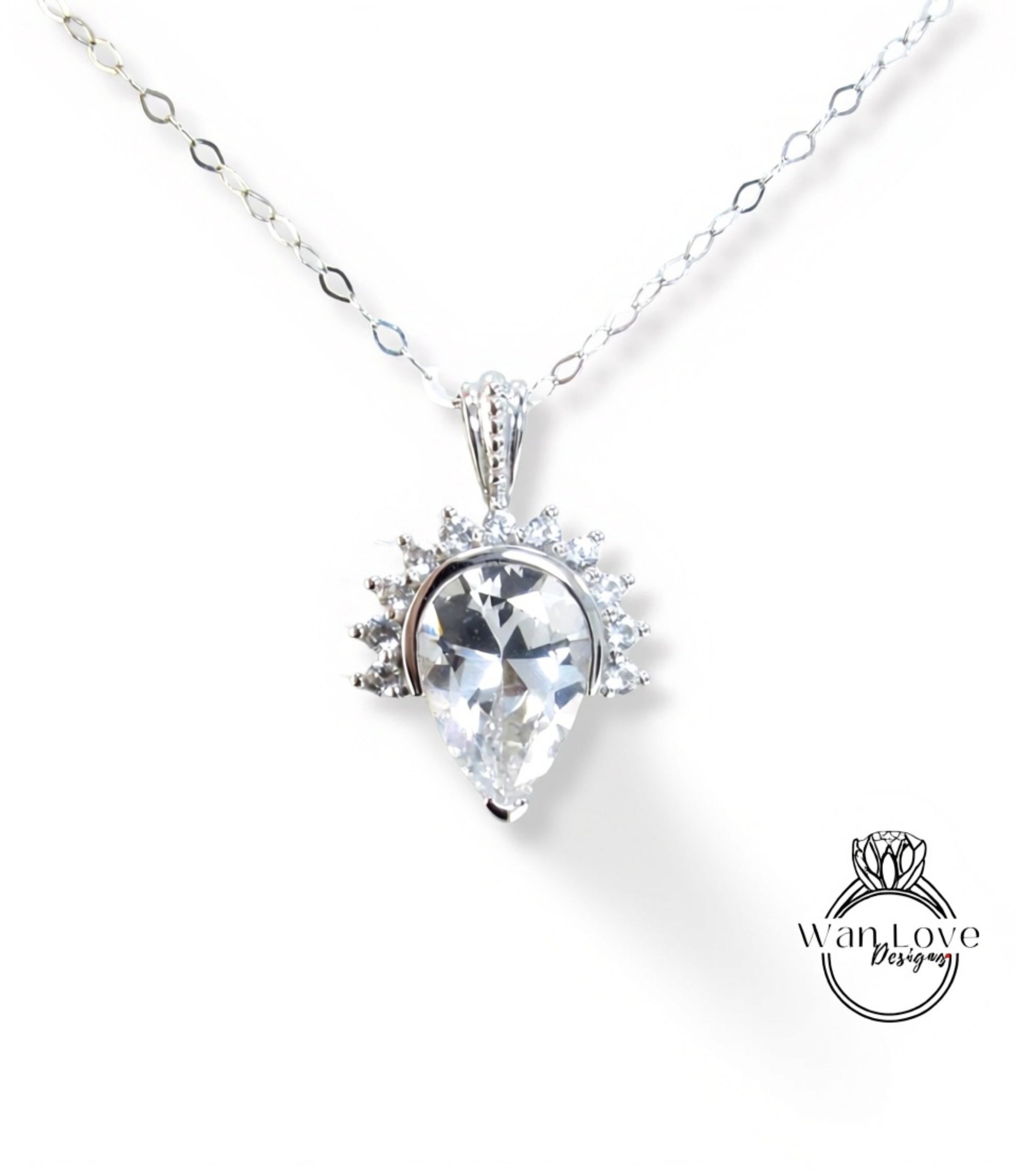 A necklace with a large, clear gemstone pendant, which appears to be a diamond or crystal.