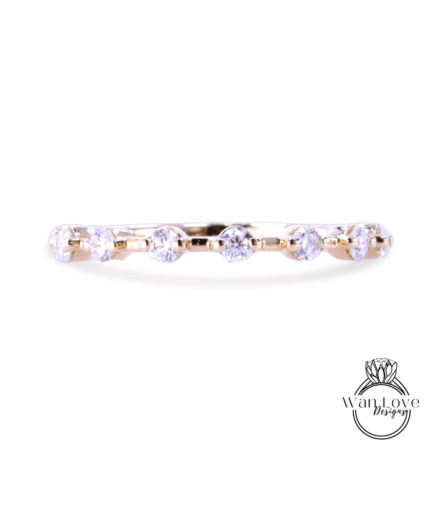 A gold ring with a row of clear diamonds set in it.