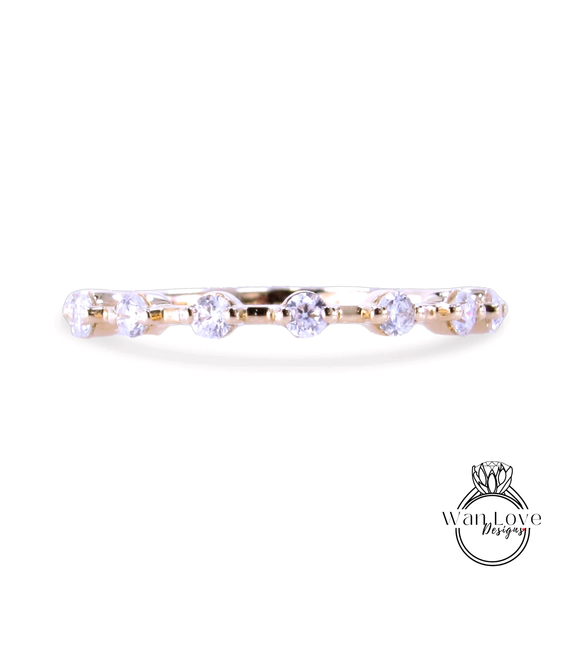 A gold ring with a row of clear diamonds set in it.