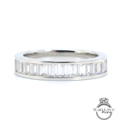 A silver band ring with a row of clear gemstones set in it.
