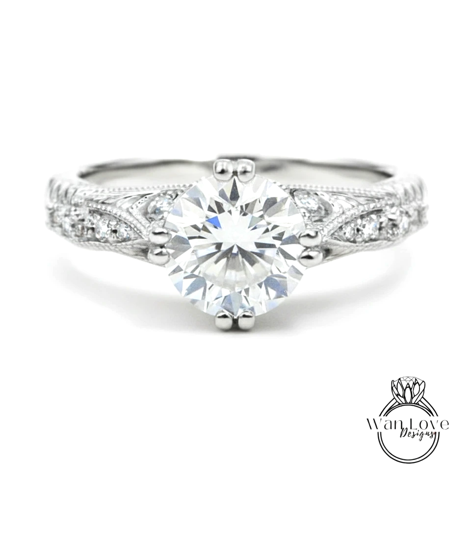 A close-up view of a diamond engagement ring with a large central diamond surrounded by smaller diamonds on either side.