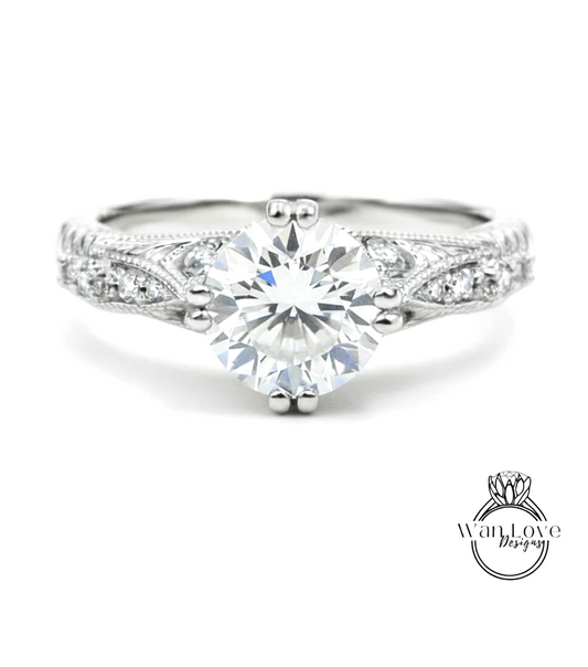 A close-up view of a diamond engagement ring with a large central diamond surrounded by smaller diamonds on either side.