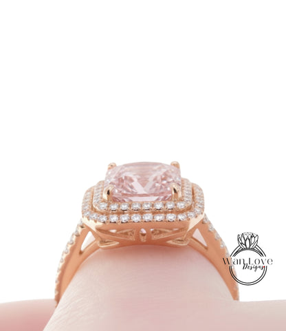 A close-up view of a gold ring with a large pink gemstone, showcasing the intricate design and sparkling details.
