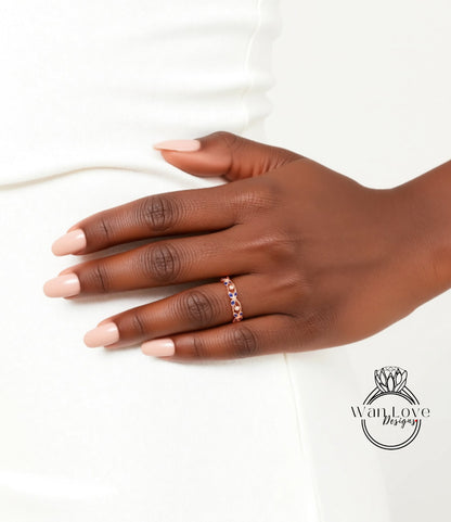A close-up of a hand wearing a ring on the ring finger, with a white background.