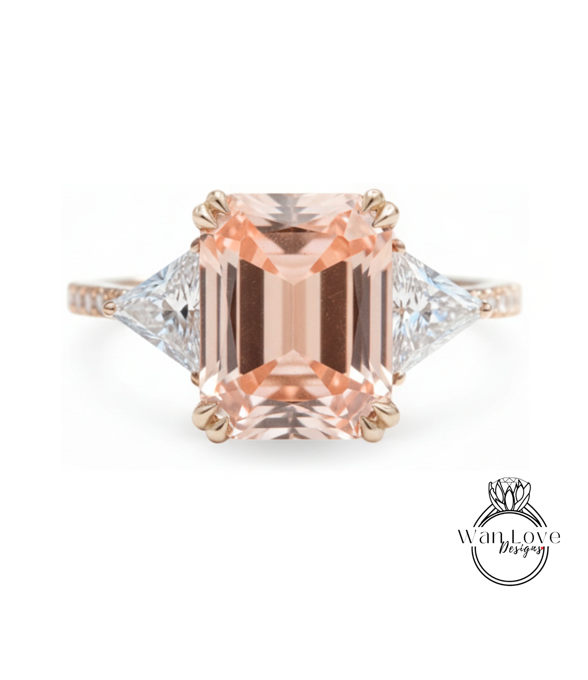 A large, peach-colored gemstone engagement ring with a gold band and two smaller diamonds on either side.