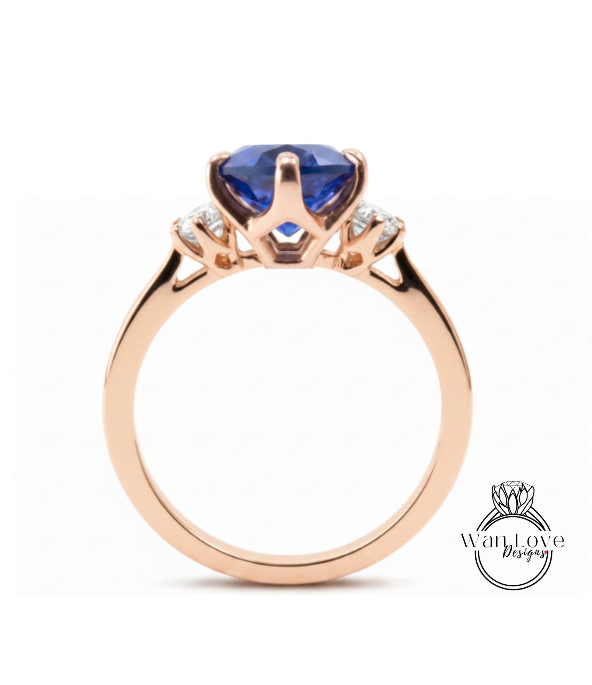 A gold ring with a large blue gemstone, possibly a sapphire, set in a three-pronged design.