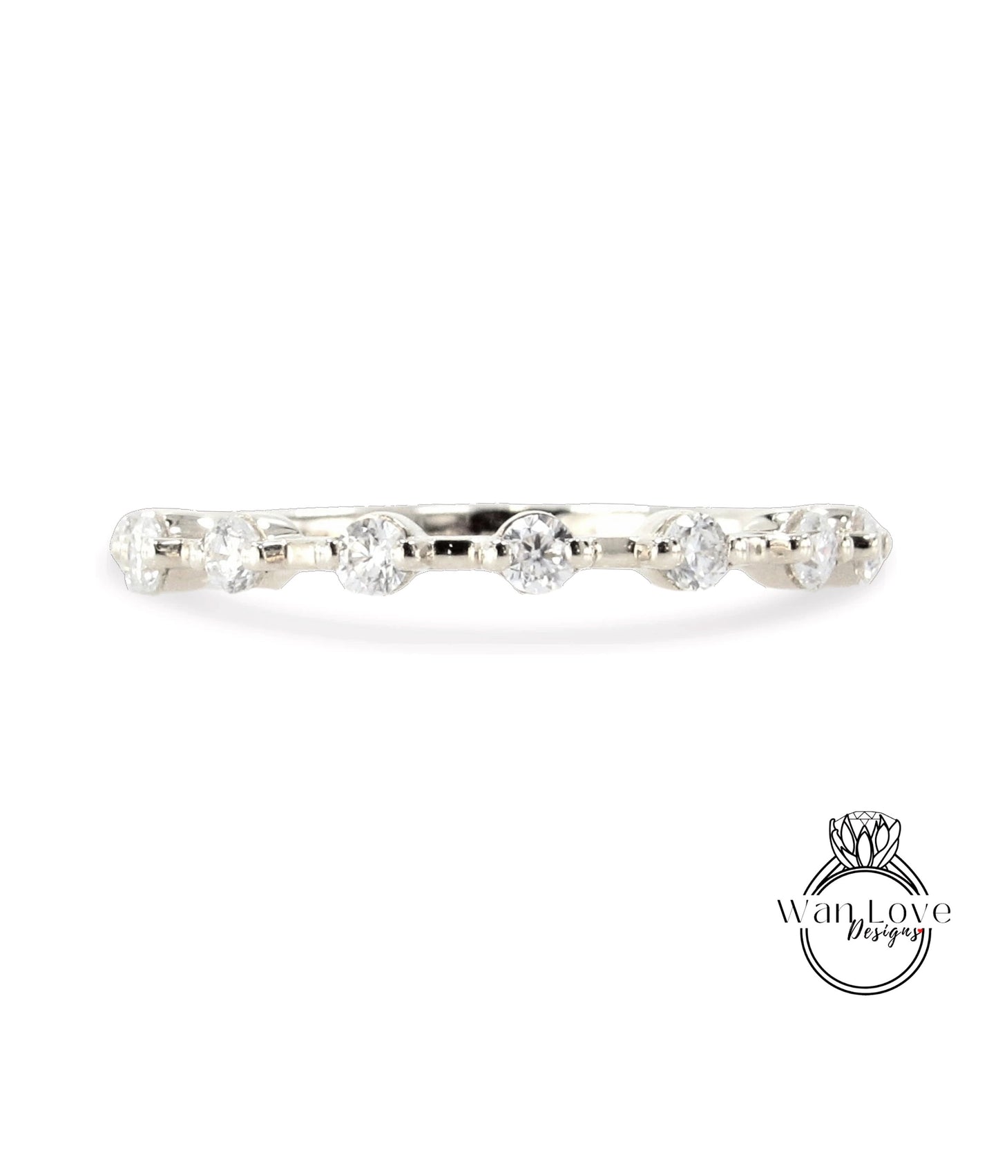 A silver ring with a row of clear diamonds set in it.