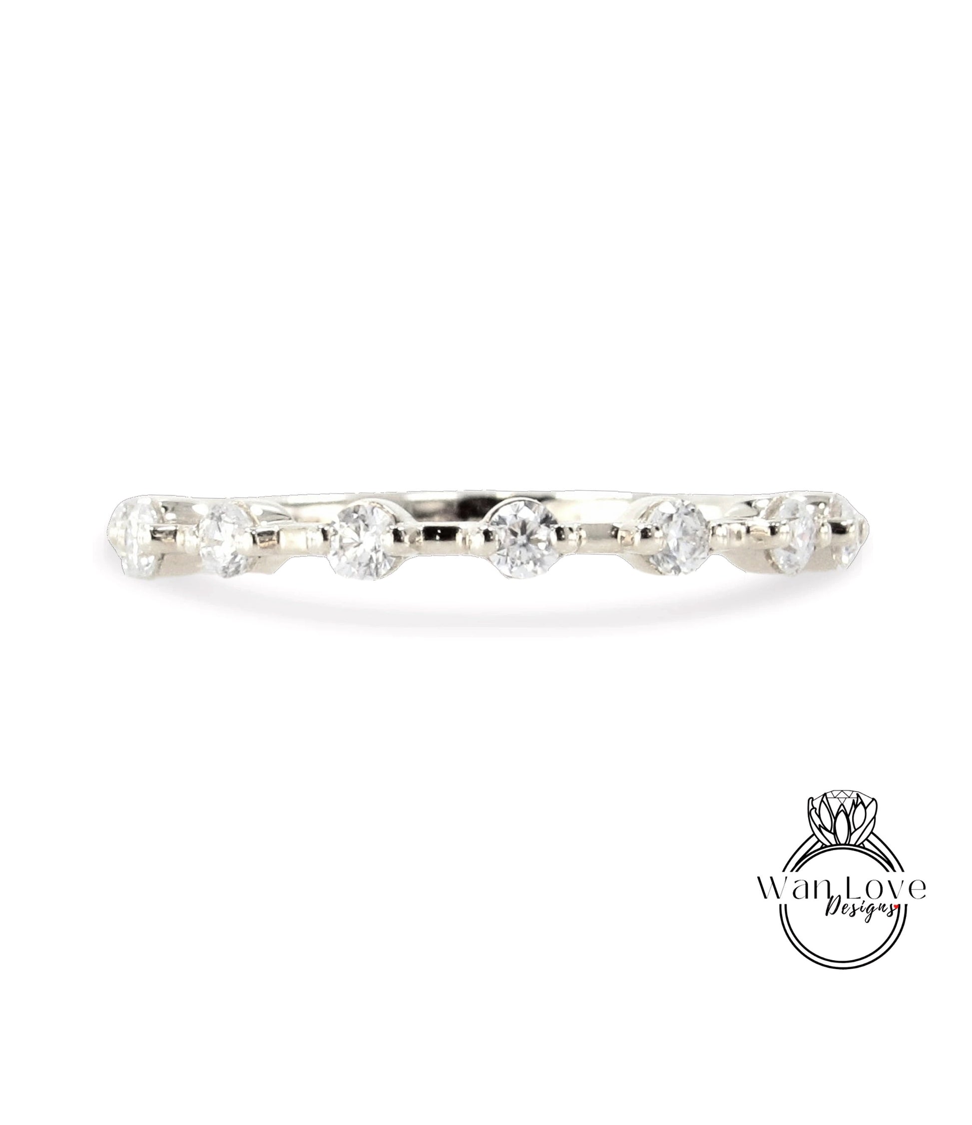 A silver ring with a row of clear diamonds set in it.