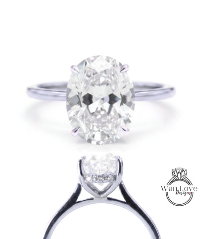 A close-up view of a diamond engagement ring with a large oval-shaped diamond set in a silver band.