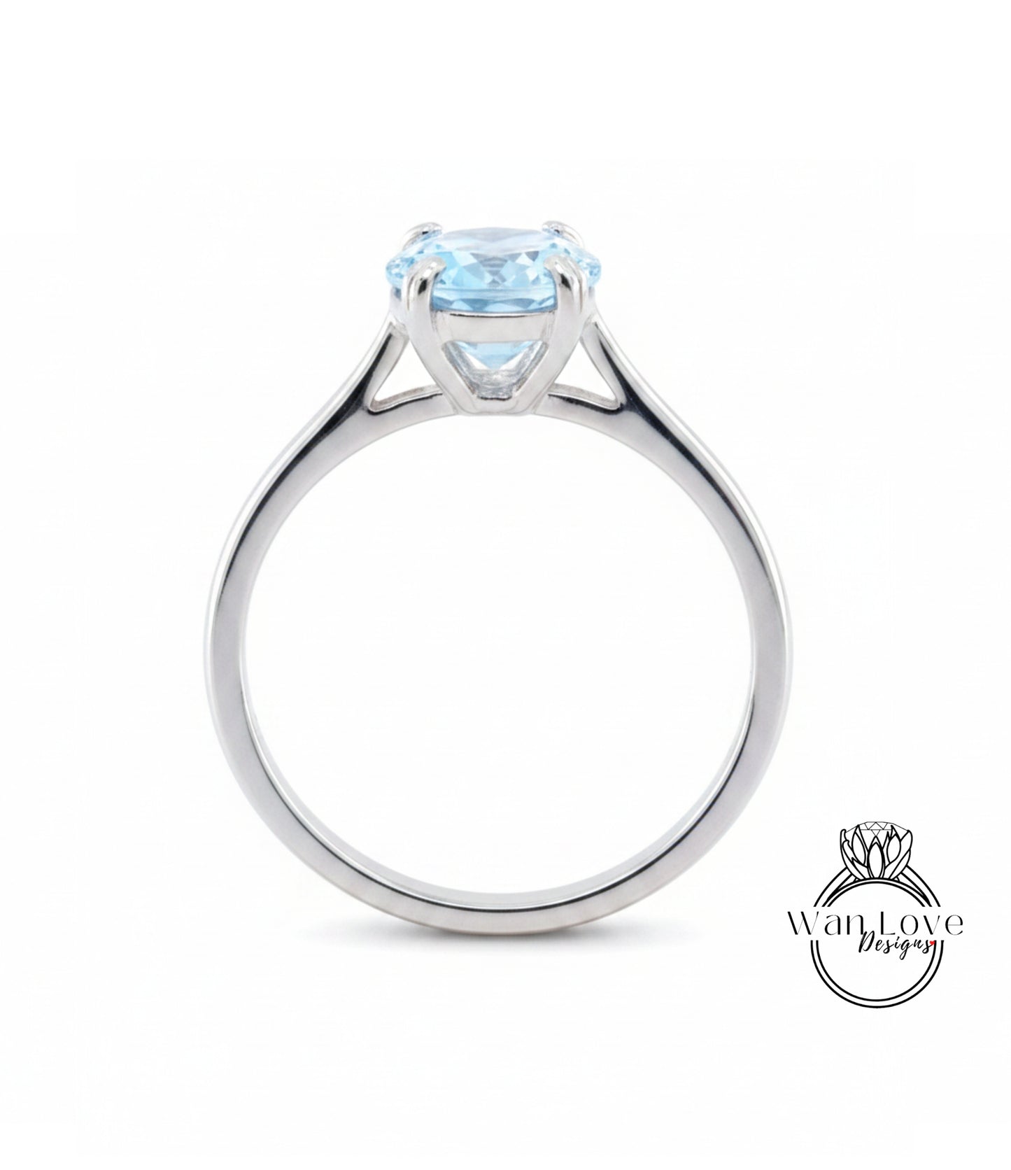 A silver engagement ring with a large blue gemstone set in the center.