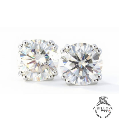 two large, clear, and brilliant-cut diamonds set in silver earrings.