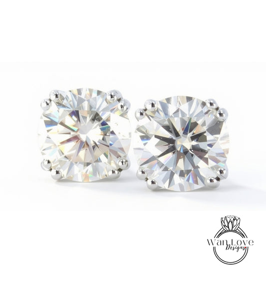 two large, clear, and brilliant-cut diamonds set in silver earrings.