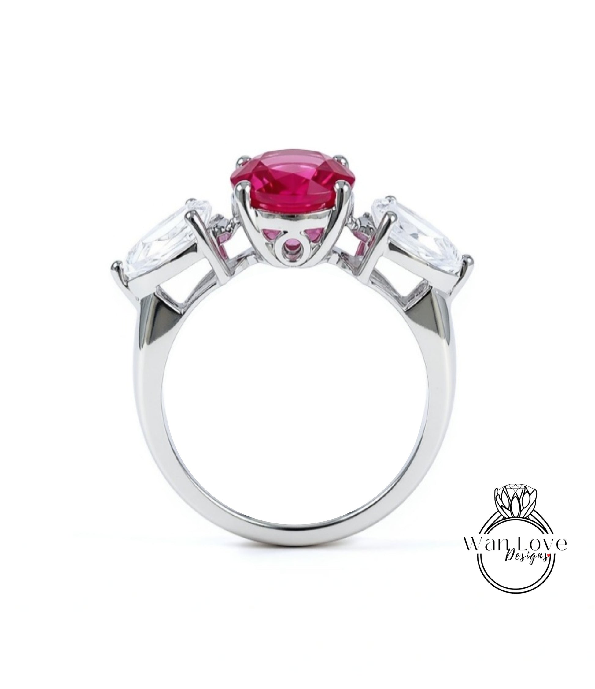 A silver ring with a large pink gemstone in the center, surrounded by smaller white gemstones.