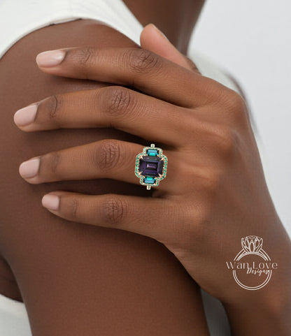 A close-up of a person's hand wearing a ring with a large, colorful gemstone.