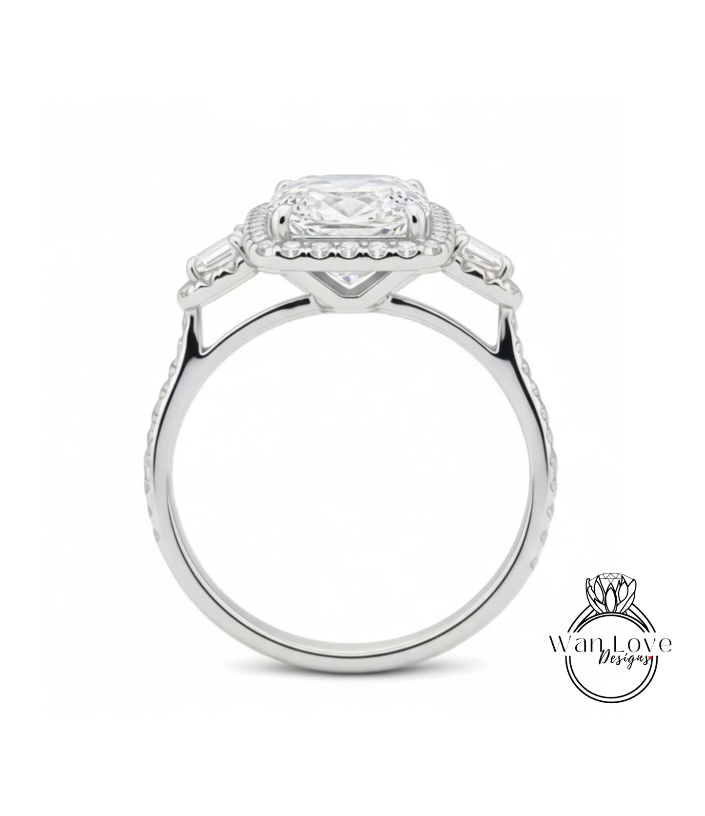 A silver engagement ring with a large central diamond surrounded by smaller diamonds on either side.