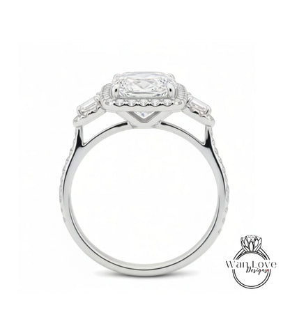A silver engagement ring with a large central diamond surrounded by smaller diamonds on either side.